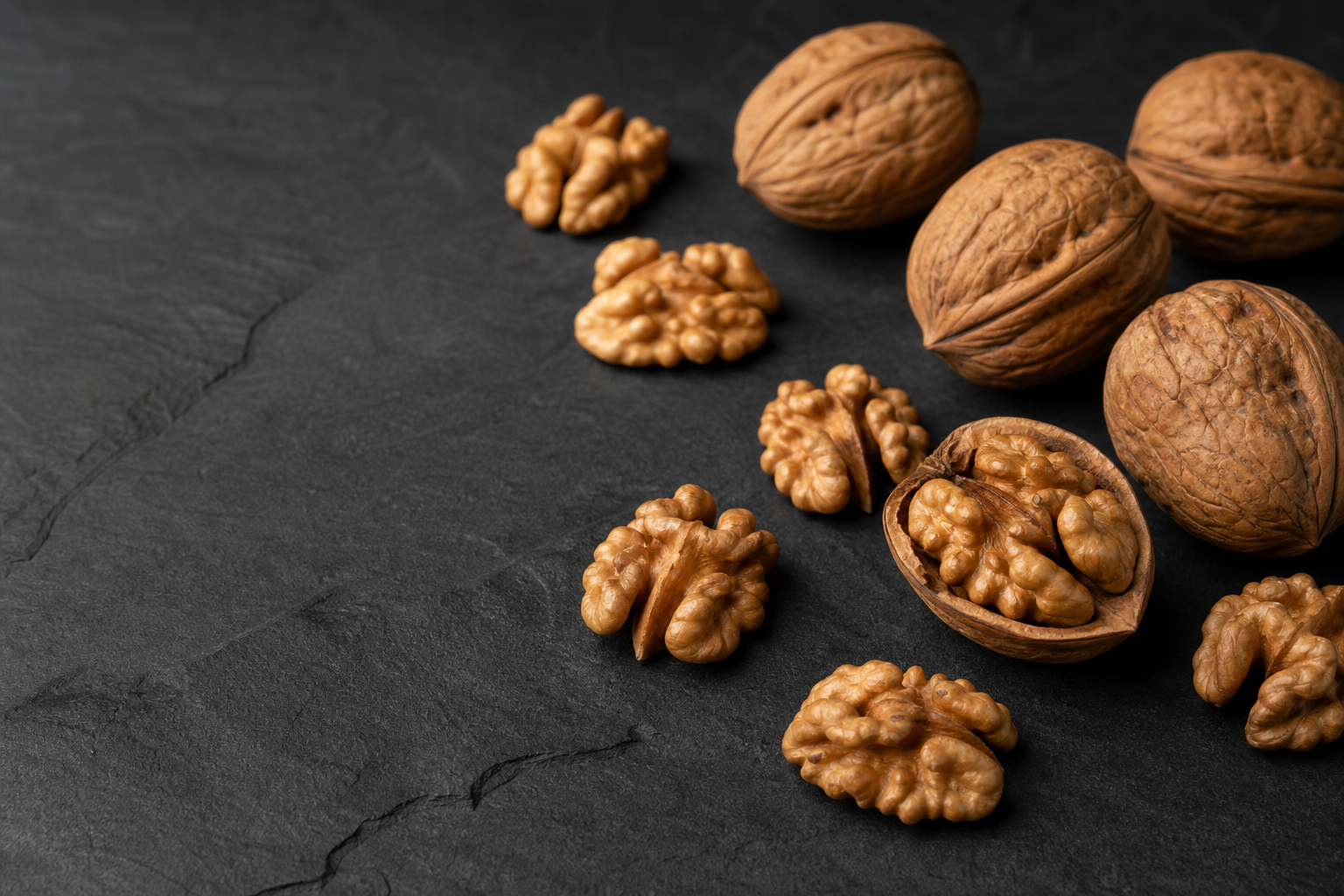 Walnuts on dark slate